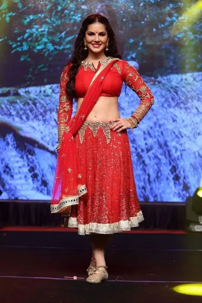 SUNNY LEONE IMAGES IN RED SAREE AT TELUGU MOVIE AUDIO LAUNCH 4